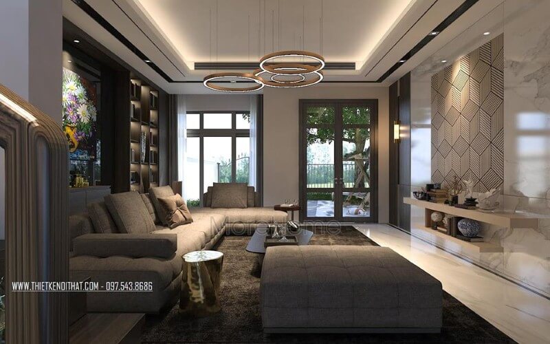 Bố trí nội thất phòng khách ấn tượng với cách kết hợp hài hòa giữa sắc trầm và sáng cùng hệ cửa kính lớn giúp không gian trở nên thông thoáng, sang trọng. ý tưởng thiết kế phòng khách đẹp tiện nghi nhất